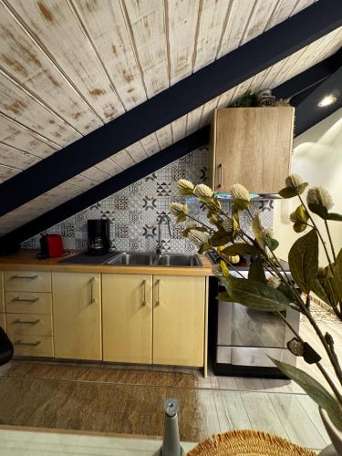a kitchen with yellow cabinets and a sink at Sofita La Vita in Preveza