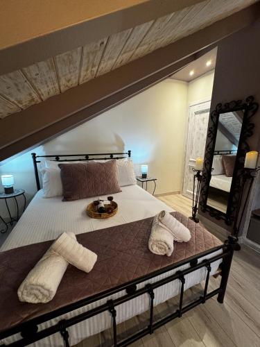 a large bed with towels on it in a bedroom at Sofita La Vita in Preveza