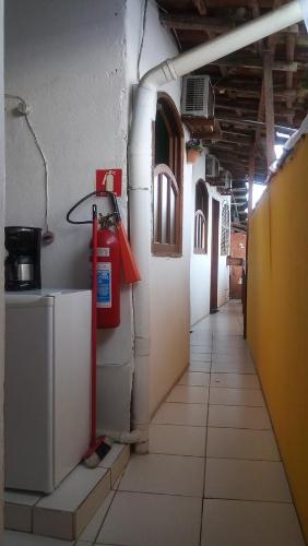 a hallway of a building with a fire hydrant on the wall at Hospedagem Casa De Familia in Paraty