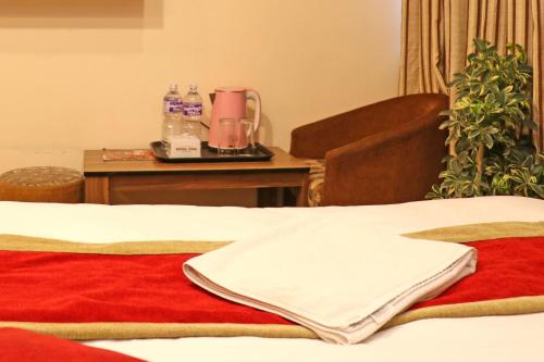 a room with a bed and a table with a blender at Hotel Airport Holiday in Kathmandu
