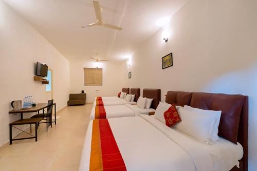 a room with a row of beds in a room at The Sanihara Hotel & Resort in Vythiri