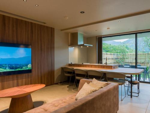 a living room with a couch and a large window at Rakuten STAY TERRACE Hakone Kowakudani in Hakone