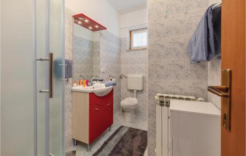 a bathroom with a red sink and a toilet at 7 Bedroom Nice Home In Labin in Labin