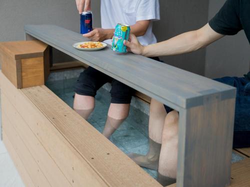 a person sitting at a table with a plate of food at Rakuten STAY TERRACE Hakone Kowakudani in Hakone