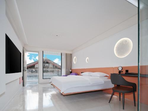 Voodi või voodid majutusasutuse 丽江熹v空中花园智能观景酒店 toas