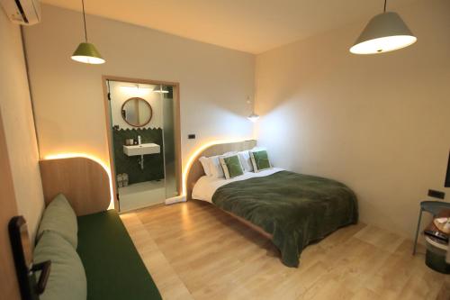 a small bedroom with a bed and a mirror at Green Inn Kaohsiung in Kaohsiung