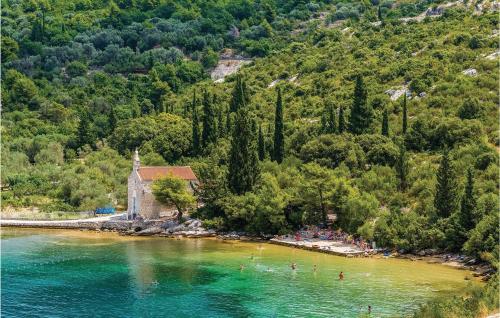 a group of people on a beach in the water at Two-Bedroom Apartment In Slano in Slano