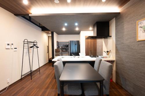 a kitchen and living room with a table and chairs at JPRESERVE Fuji in Nishinotōindōri