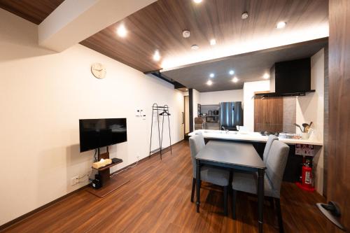 a living room with a dining room table and a kitchen at JPRESERVE Fuji in Nishinotōindōri