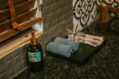 a bottle of wine sitting on a table next to a towel at Anna Little Garden - Fish House in Sóc Sơn