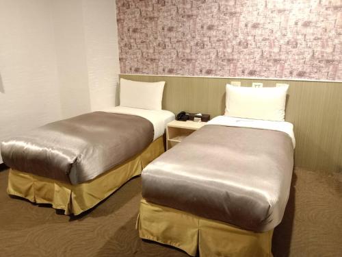 Ένα ή περισσότερα κρεβάτια σε δωμάτιο στο Ximen Hotel