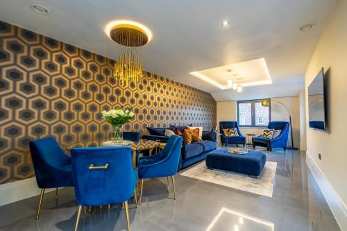 a living room with blue chairs and a blue couch at Boutique Apartment at The Old Fire Station in York