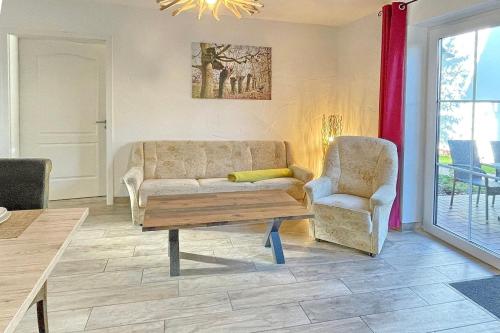 a living room with a couch and a chair at Blockhaus Baum 3 in Burg