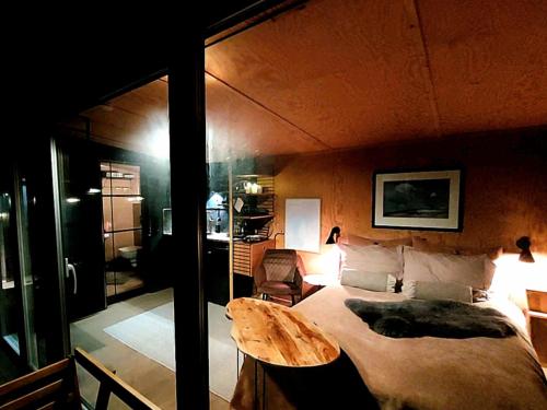 a bedroom with a large bed and a table at fjord : oslo in Nordstrand