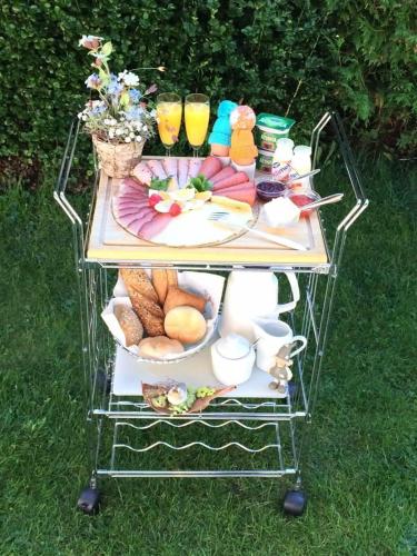 a cart full of food and drinks on a table at Haus am Bühel in Gaschurn