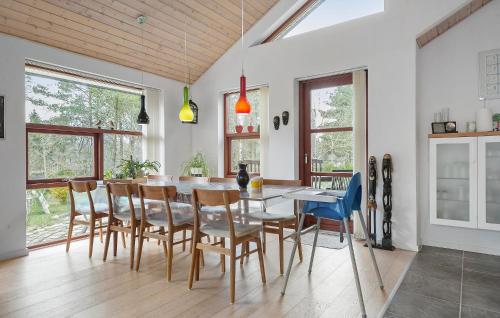 a dining room with a table and chairs at 3 Bedroom Cozy Home In Silkeborg in Silkeborg