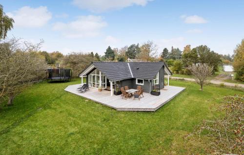 a small house with a deck in a yard at Awesome Home In Præstø With Wifi in Præstø
