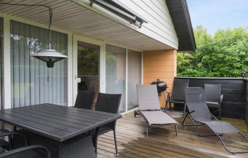 a patio with a table and chairs on a porch at Gorgeous Home In Hemmet With Wifi in Hemmet