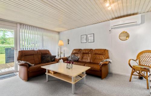 a living room with a couch and a coffee table at Gorgeous Home In Hemmet With Wifi in Hemmet