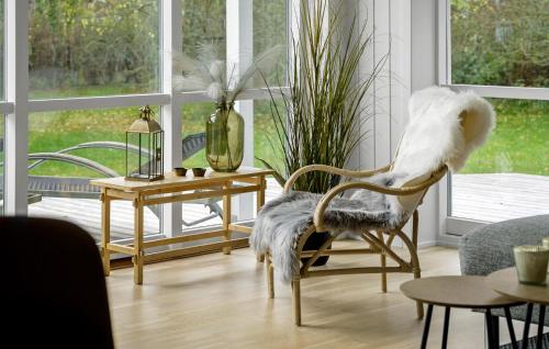a living room with a chair with a bird on it at Awesome Home In Præstø With Wifi in Præstø