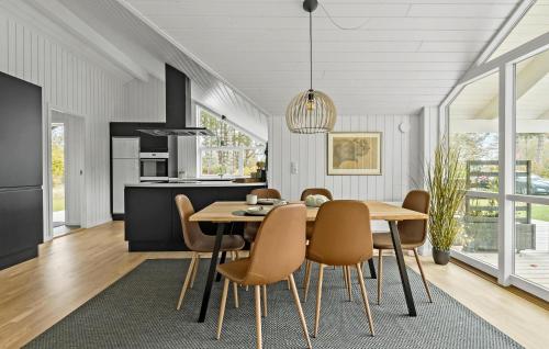 a kitchen and dining room with a table and chairs at Awesome Home In Præstø With Wifi in Præstø