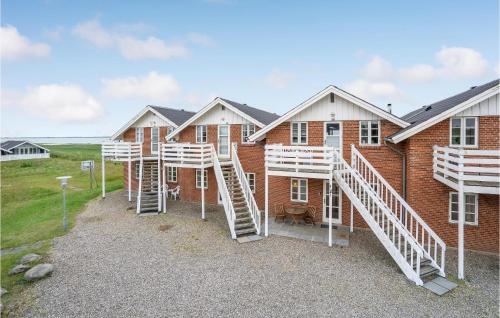 a group of houses with white stairs in front of them at Amazing Home In Rømø With Kitchen in Havneby