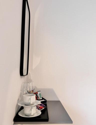 a tray with cups and saucers on a table at Camden Luxury Studio Flats and En-Suit Rooms in London