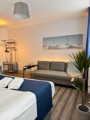 a living room with two beds and a couch at Camden Luxury Studio Flats and En-Suit Rooms in London