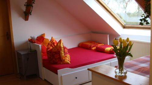 a room with a bench with colorful pillows on it at Ulfershausen in Wangerland
