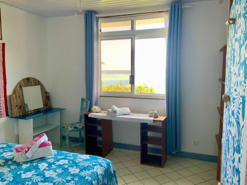 Postel nebo postele na pokoji v ubytování Maison avec vue exceptionnelle lagon et mer, accès privé lagon