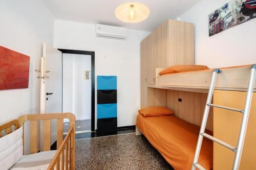 a bedroom with two bunk beds and a staircase at Attico in centro vista mare in Chiavari