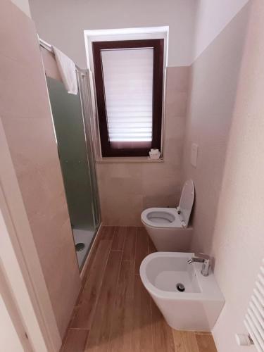 a small bathroom with a toilet and a window at Villa MARGHERITA in Pratola Peligna