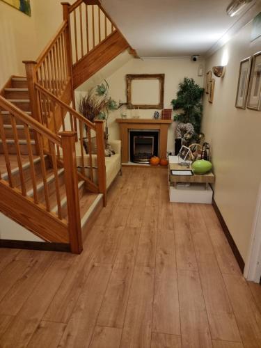 a living room with stairs and a fireplace at Travel Plaza Hotel in Desborough