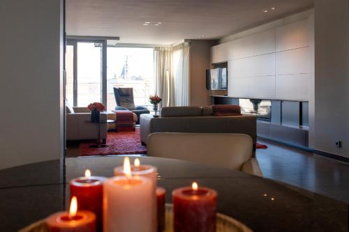 a living room with two candles on a table at Alizee - fam penthouse - 3 parkings in Knokke-Heist