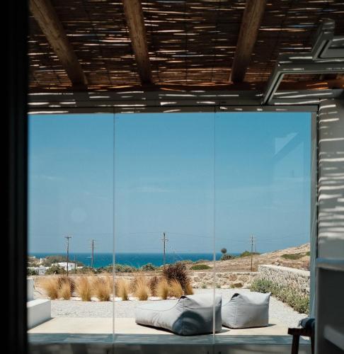 a glass wall with a view of the ocean at Villa ilios, Stelida Naxos, by NaxosVibe in Naxos Chora