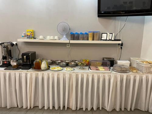 a white table with food on top of it at Hotel Zlatý Anděl in Žatec