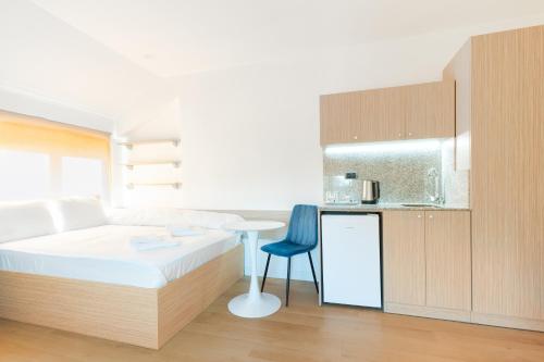 a bedroom with a bed and a table and a kitchen at Millennia Hotel in Sofia