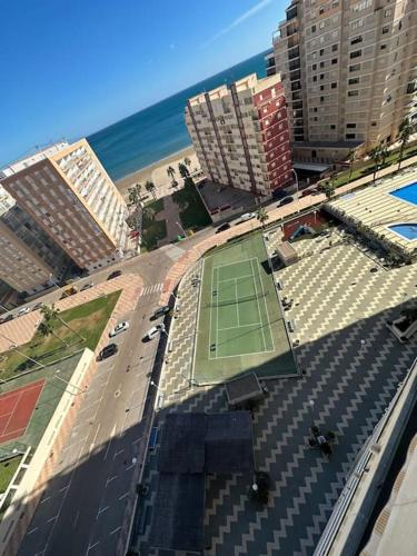 a tennis court on a street next to the beach at Apto con encanto en primera línea de playa , Cullera in Cullera