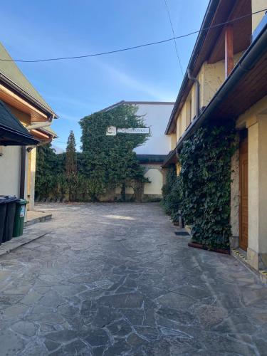 an empty courtyard with ivy on the side of a building at Penzión Weinerovka Varín in Žilina
