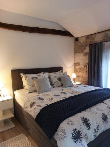 a bedroom with a large bed with a white bedspread at Holiday Home Demark in Jurdani