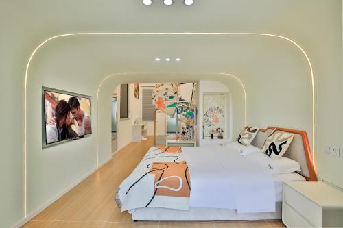 a bedroom with a bed with a painting on it at 上海乡韵亲子酒店 in Shanghai