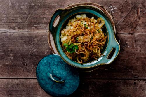 a bowl of food sitting on a wooden table at AlpenParks Hotel Maria Alm in Maria Alm am Steinernen Meer