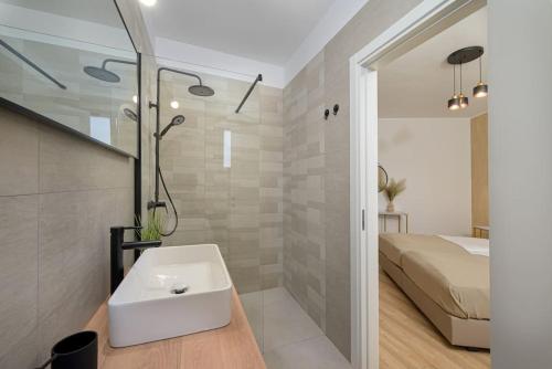 a bathroom with a sink and a bed at Villa Drandic by IstriaLux in Bale
