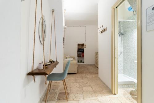 une pièce avec une chaise, un bureau et une baignoire dans l'établissement Dimora Marter, city center, à Conversano