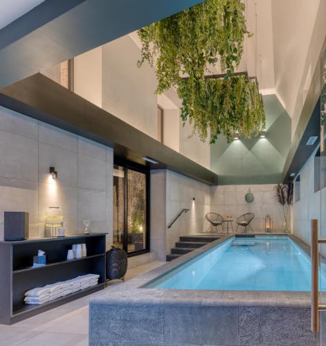 an indoor pool in a house with a house at Brit Hotel Les Voyageurs in Loudéac