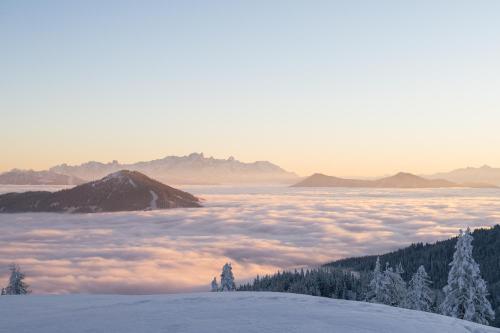 a view of a layer of clouds in the mountains at AlpenParks Hotel Maria Alm in Maria Alm am Steinernen Meer