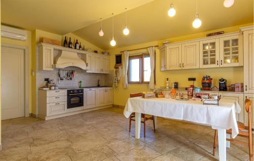 a kitchen with a table in the middle of it at Amazing Home In Morrovalle With Wifi in Morrovalle
