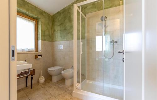 a bathroom with a shower and a toilet and a sink at Amazing Home In Morrovalle With Wifi in Morrovalle