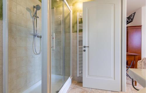 a bathroom with a shower and a glass door at Amazing Home In Morrovalle With Wifi in Morrovalle