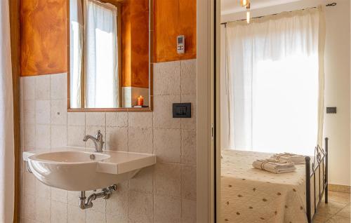 a bathroom with a sink and a window at Amazing Home In Morrovalle With Wifi in Morrovalle